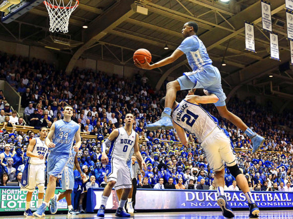 North Carolina's John Henson jumps over Duke's Miles Plumlee during the first half of their game in Durham, North Carolina.
